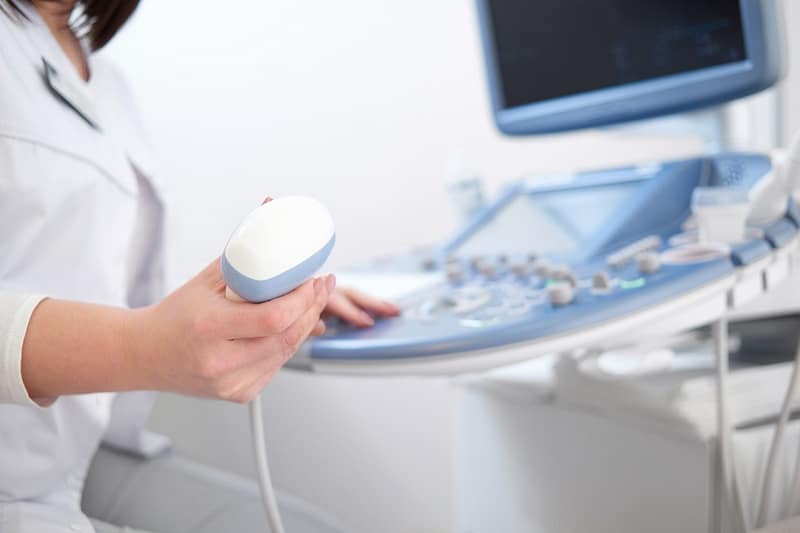 female-doctor-sitting-her-office-near-ultrasound-sc