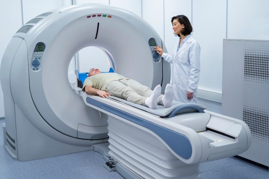 Illustration depicting CT scan machine with medical professionals adjusting settings