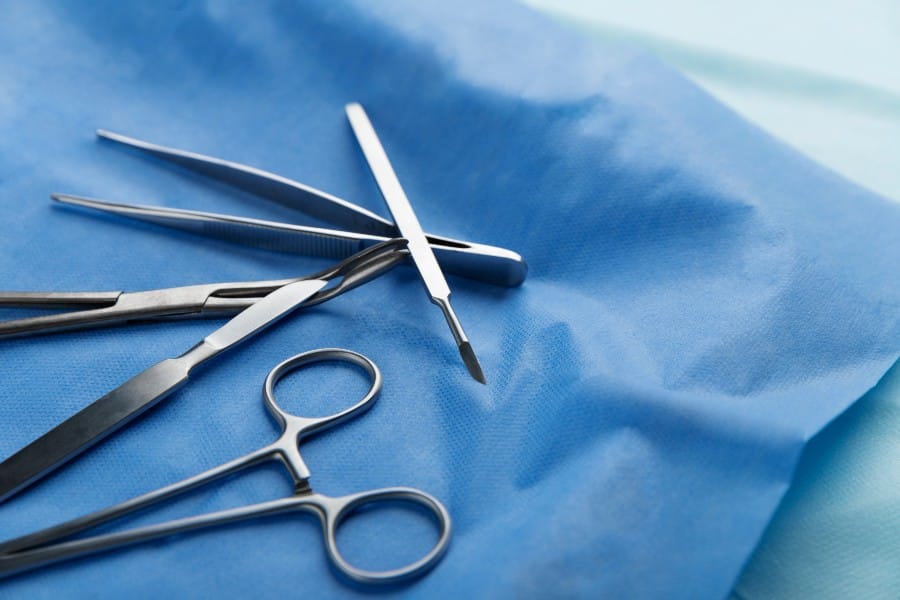 Various surgical instruments are neatly arranged on a sterile surface.