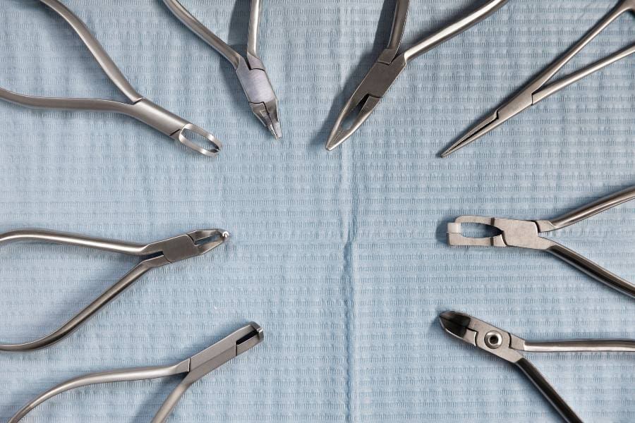 A circle of surgical instruments on a table.